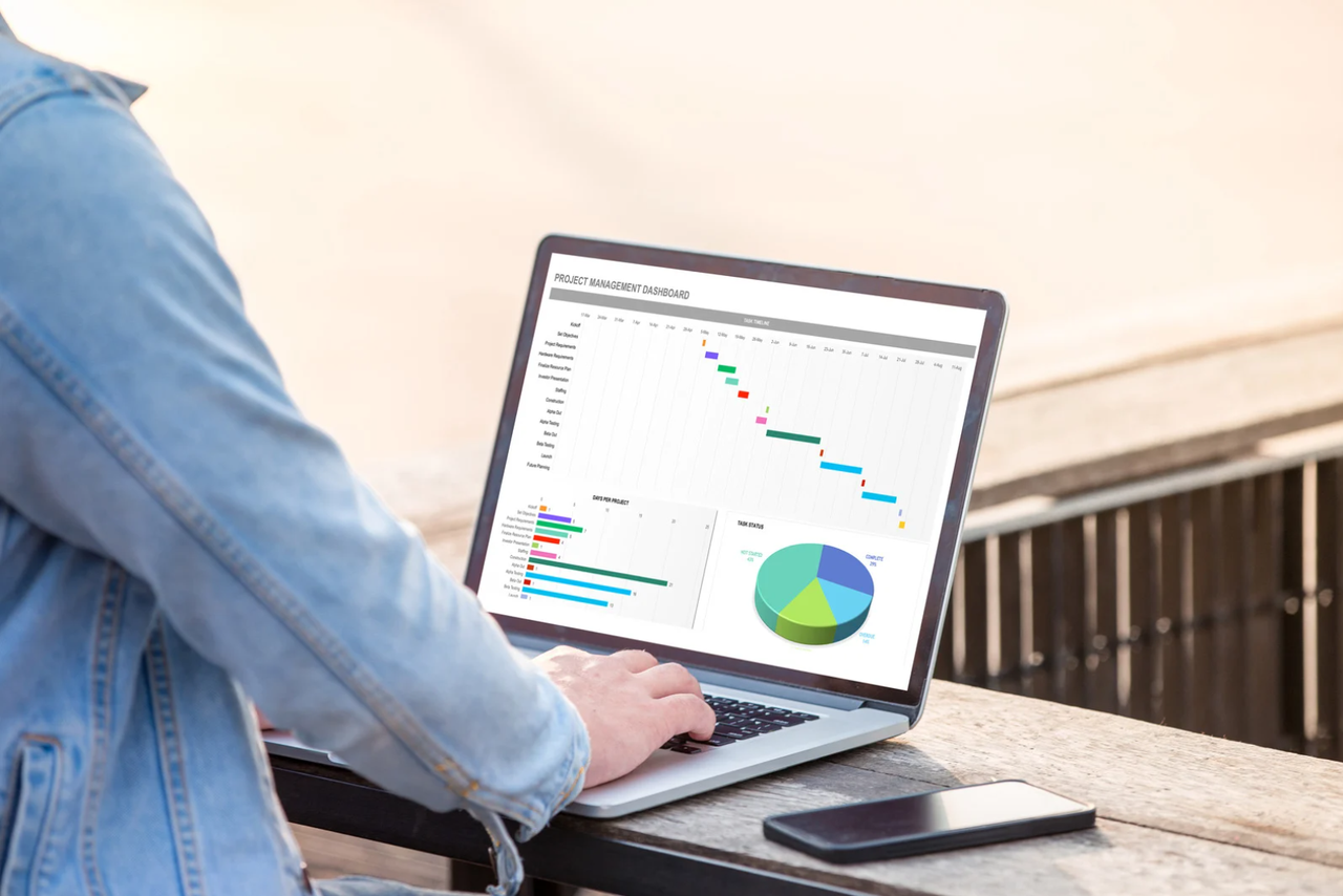 A person analyzing charts on a laptop